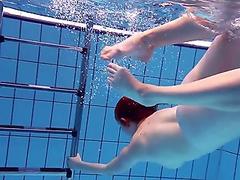 Long hair solo model with natural tits swimming showing off her nice ass